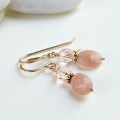 Our gold peach moonstone earrings shimmer like the sky at sunset. Sparkling European crystal and faceted peach moonstone dangle from handmade 14k gold filled earrings.  Wear the June birthstone earrings to showcase your birth month or gift the moonstone crystal to Mom on Mother's Day.  The dainty drop earrings add sparkle and a pop of peach to your wardrobe.  Made with high-quality materials and craftsmanship, the pair will be a treasured member of your jewelry collection EASY TO GIFT:  The moon Earrings For Mom, Jasper Earrings, Birthstone Earrings, Moonstone Crystal, Moonstone Earrings, Peach Moonstone, Gold Filled Earrings, June Birthstone, Moonstone Jewelry