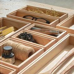 the drawers are organized with scissors, thread and other crafting supplies for making eyeglasses