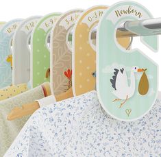 a row of baby bibs hanging from hooks