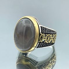 Discover the timeless beauty of our Yemeni Aqeeq Ring, meticulously handcrafted with love and care. Made from 925 Sterling Silver, this exquisite men's ring combines traditional craftsmanship with a touch of elegance. The centerpiece of this striking piece is a genuine Yemeni Aqeeq stone, known for its deep red hues and believed to hold mystical and protective properties. Each stone is carefully selected to ensure its unique and captivating patterns, making every ring a one-of-a-kind masterpiece. This Yemeni Aqeeq Ring isn't just a piece of jewelry; it's a statement of style and heritage. Its bold yet refined design is reminiscent of Ottoman aesthetics, reflecting a rich history and culture. Whether you wear it as a symbol of strength, protection, or simply as a fashion statement, this rin Classic Polished Moonstone Ring Gift, Round Signet Ring With Stone Setting As Gift, Classic Signet Ring With Stone Setting As Gift, Classic Signet Ring With Stone Setting For Gift, Classic Rings With Stone Setting As Gift, Classic Rings With Stone Setting For Gift, Spiritual Gemstone Signet Ring For Anniversary, Classic Moonstone Ring For Gift, Classic Moonstone Ring As Gift