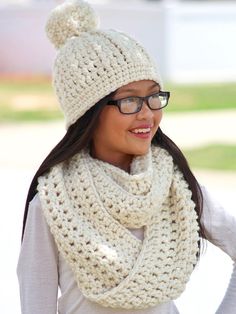 a woman wearing a white knitted hat and scarf