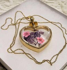 "Beautiful dry flowers in crystal diamond cut glass heart. Moving lavender and forget-me-not Gold tone heart frame and chain. A gorgeous romantic piece of jewelry. Size:  Pendant: 1.25\" x 1.25\" Chain: 23\" Perfect condition. Excellent gift. FREE SHIPPING Thank you for visiting my store. You can also visit my AmazingClosetShop or http://jewelryandclothing.net/ Please read \"The Private Policy\"" Delicate Heart-shaped Keepsake Jewelry, Delicate Keepsake Jewelry For Valentine's Day, Pressed Flowers Jewelry For Valentine's Day Gift, Pressed Flowers Jewelry Gift For Valentine's Day, Valentine's Day Jewelry With Pressed Flowers For Gift, Valentine's Day Jewelry Gift With Pressed Flowers, Lavender Jewelry With Pressed Flowers For Gifts, Heart-shaped Clear Jewelry For Gifts, Heart-shaped Clear Jewelry Gift