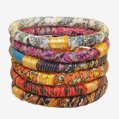 Upcycled sari fabrics make a statement in these beautiful bangles wrapped in a gold accent. Named for the Sanskrit word for "girl". Parisian Jewelry, Beautiful Bangles, Sanskrit Words, Earth Color, Sari Fabric, Beach Boho, Blues And Greens, Gold Accent, Jewelry Companies