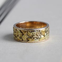 "A wonderfully unique wide vintage stacking band crafted in 14k inlaid around the outside with natural gold ore nuggets. Dated on the inside with an inscription \"Today and tomorrow R.K.H. 80-6-13\", the arrangement of the date numbers suggests European origin. Gold nuggets usually contain between 85 percent and 95 percent pure gold, depending on the other naturally occurring metals in the vein, anrd the nuggets have rich varied color ranging from bright yellow to warm honey gold. Easy to wear o Heirloom Yellow Gold Jewelry With Thick Band, Heirloom Thick Band Yellow Gold Jewelry, Gold Engraved Thick Band Jewelry, Gold Jewelry With Engraved Thick Band, Heirloom Wide Band Engraved Jewelry, Engraved Wide Band Heirloom Jewelry, Antique Wide Band Engraved Jewelry, 14k Yellow Gold Nugget Jewelry, 14k Gold Engraved Jewelry With Thick Band