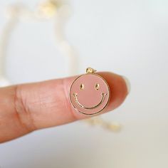 "Beautiful and lovely happy face charm necklace. Made of blush enamel smiley face charm with skinny gold plated brass chain. Soft and warm. Great for a gift, every day or special occasion. Your item will ship in a gift box. Please feel free to contact me if you have any questions. ♥ Length 14\" -20\" chain ♥ Charm 5/8\" x 3/4\" ♥ Gold plated over brass / Blush enamel ♥ Delivery Time Fast shipping within 1 - 3 days ♥ See more Rudiana Accessories Rudiana.etsy.com" Trendy Nickel-free Pink Charm Necklace, Everyday Pink Charm Necklaces, Personalized Pink Charm Necklace For Everyday Wear, Personalized Pink Charm Necklace For Everyday, Everyday Pink Charm Necklace, Pink Smiley Face Jewelry For Everyday, Cute Pink Charm Necklace For Best Friend, Smiley Face Necklace, Preppy Gifts