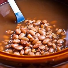 a bowl filled with beans and a spoon