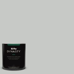 a can of paint sitting on top of a white floor next to a black wall