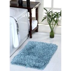 a blue rug is on the floor next to a washer