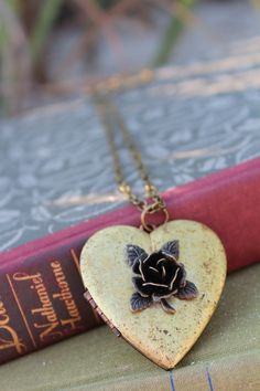 Note: I am unable to put quotes in the heart shaped vintage lockets. Thank you for understanding. This rustic heart locket is restored vintage. I added a dark bronze 3D Rose on the front. The contrast of the colors is stunning. The locket is generous, measuring 47mm! It holds two photos and the inside has a copper perimeter to hold them in tightly. It hangs on a brass chain and closes securely with a lobster clasp. Gorgeous gift or a lovely vintage accessory for you collection. It comes beautifu Vintage Antique Gold Heart Pendant Necklace, Antique Gold Heart Pendant Vintage Necklace, Vintage Heart Charm Necklace For Valentine's Day, Antique Gold Heart Necklace With Vintage Charm, Handmade Vintage Heart Necklace, Vintage Heart-shaped Necklace With Vintage Charm, Vintage Heart Necklaces With Vintage Charm, Vintage Heart Necklace With Charm, Heart-shaped Locket Necklace With Vintage Charm