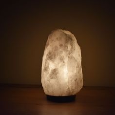 a rock lamp sitting on top of a wooden table