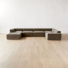 a large sectional couch sitting on top of a hard wood floor