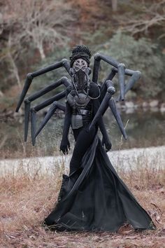 a woman dressed up as a spider in a field