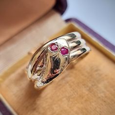 "A fantastic vintage ring shaped as a coiled snake, the head featuring two round rubies to represent the eyes, fully hallmarked and dating to the year 1966. Snake jewellery is said to represent eternity or infinity - it dates back many centuries and remains popular and collectable to this day. Hallmarked as 9ct gold, dated Birmingham 1966. Maker's mark \"C.P.S\" for CPS Jewellery Co Ltd of Vyse Street, Birmingham. The width of the band measures approximately 9.8mm (widest) to 7.0mm (slimmest). The approximate weight is 4.8 grams. Please note that the antique ring box is for display purposes only. Thank you. Ring size T (UK) or 9 5/8 (US) - this ring can be adjusted in size in our workshop. Please get in touch to discuss sizing options and lead time. Please note that for UK to US ring sizes Antique Snake-shaped Yellow Gold Jewelry, Antique Hallmarked Snake Ring, Antique Hallmarked Ruby Ring For Ceremonial Occasion, Antique Snake Ring As Gift, Vintage Snake-shape Jewelry For Formal Occasions, Vintage Yellow Gold Snake Jewelry, Elegant Hallmarked Snake Ring, Vintage Engraved Snake Ring As A Gift, Heirloom Hallmarked Snake Ring As Gift