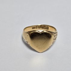 Unique 18ct Yellow Gold Heart-Shaped Signet Ring | UK Ring Size T | Romantic & Bold Statement Discover a rare treasure with this unique 18ct yellow gold heart-shaped signet ring. A symbol of love and individuality, this distinctive piece showcases a timeless design in luxurious 18ct gold. Perfect for making a bold statement or expressing your unique style, this ring is sure to become a cherished heirloom. Features: Metal: 18ct Yellow Gold Ring Type: Signet Ring Shape: Heart Ring Size: T (UK) Rin Heart Signet Ring, Ring Heart, Signet Rings, Ring Der O, Gold Signet Ring, Ring Shapes, Love Symbols, Gold Heart, Types Of Rings