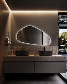 a bathroom with two sinks and a large mirror