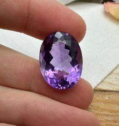 Natural Quartz (Amethyst)  Measurements: 20.0 x 14.9 mm, 10.62 mm deep   Weight: 19.11 carats Cut: Oval  Color: Medium Purple, (the stone is a little more purple and less bluish in person than the photos show) Clarity: VS-VVS, Eye Clean! This amethyst was recycled from pre-owned gold jewelry Oval Amethyst Gemstones For Formal Occasions, Formal Oval Amethyst Gemstones, Elegant Oval Amethyst Ring With Natural Stones, Purple Oval Classic Gemstones, Classic Oval Purple Gemstones, Classic Purple Oval Gemstones, Oval Purple Amethyst Gemstones, Oval Amethyst Gemstones With Accents, Oval Amethyst Gemstones With Gemstone Accents