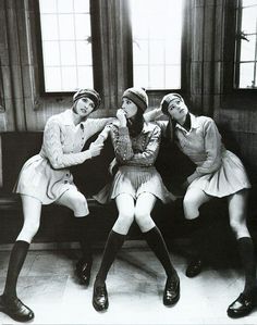 black and white photograph of three women sitting on a bench