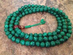 This full mala 108 beads prayer mala is made by malachite beads. This mala is used for meditation purposes or can always be used as necklace or bracelet by wrapping around your wrist. The length of the mala is about 35 inches and bead size about 7-8mm. Beads are strung on a durable nylon cord. This mala can be used both as bracelet by wrapping around your wrist or as a necklace. Malachite prayer bead malas provide powerful grounding energy that clears obstructions and blockages and helps avert c Green Gemstone Beads Mala For Healing, Spiritual Jade Beads For Meditation, Green Spiritual Beads For Healing, Green Mala With 8mm Beads For Healing, Green Spiritual Beads, 108 Count, Green Hand-strung Spiritual Mala, Green Spiritual Mala With 108 Beads, Adjustable Green Beaded Necklaces For Meditation, Adjustable Jade Beaded Necklace With 8mm Beads