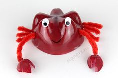 a red plastic crab with eyes and legs