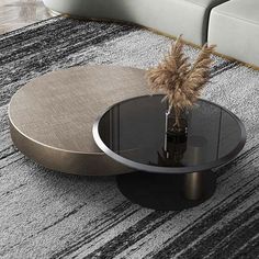 a round coffee table with a vase on top