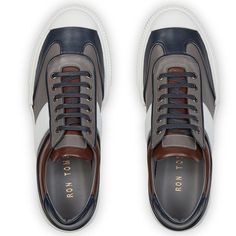 This leather lace up sneaker has been handcrafted from flawless grain leather, embellished with a leather insole that nods to the brand's heritage. Perfectly paired with tailored suits and leather jackets. Leather Lining for a luxurious feel and moisture control Leather collar and tongue Rubber sole Tapered round toe. The handmade sustainable Gommus rubber outsole and insole are Made in Italy. STYLE #D2168T Italy Style, Lace Up Sneakers, Tailored Suits, Leather Collar, Leather Lace, Leather Jackets, Navy White, Leather And Lace, Navy And White