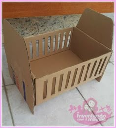 an open cardboard box sitting on the floor next to a tile floor and pink border