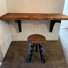 a wooden bench sitting next to a metal stool on top of a carpeted floor