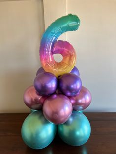 a stack of balloons sitting on top of each other in the shape of a number six