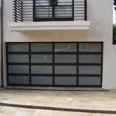 a garage door is open in front of a house