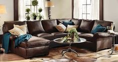 a living room filled with brown furniture and lots of window sills on the walls