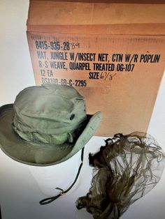 "US VIETNAM ERA OD JUNGLE BOONIE HAT 67/8 OG/107 NEW W MOSQUITO NET NIP.  Condition Brand new in original packing. Original Vietnam Era US Army OG-107 Ripstop 2nd Pattern Jungle  \"Boonie\" Hat - 1969 Contract Date  - 6 7/8 Size - NOS Unissued Condition  Up for Auction is a Vietnam Era US Army OG-107 Ripstop Tropical Jungle \"Boonie\" Hat.  The hat is in NOS Unissued Condition.  The lable has a 1969  Contract Date.  It is a Size 6 7/8.  Very RARE to find with the Original Insect Netting in this Condition.  They don't get any bettern than this one. The 2nd pattern OG-107 boonie hat was made of Quarpel (Quartermaster developed repellent) treated rip-stop cotton poplin, rather than the plain cotton of the original.  Like its predecessor it was issued with an insect net   Head Circumference Ad Green Wide Brim Fishing Hat, Green Wide Brim Hat For Fishing, Military Style Green Bucket Hat For Outdoor, Summer Military Brimmed Hats, Military Style Brimmed Hats For Summer, Military Style Brimmed Summer Hats, Military Style Visor Hat For Summer, Military Style Green Hat For Summer, Green Military Hat With Wide Brim