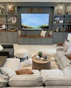 a living room filled with furniture and a flat screen tv mounted on a wall above a fire place