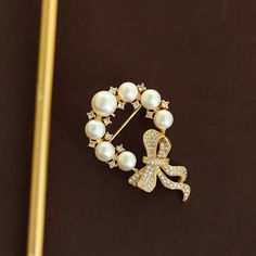 Indulge in the ultimate sophistication with our Copper Round Pearl Bow Brooch. Made with luxurious copper and adorned with a delicate round pearl, this brooch adds a touch of elegance to any outfit. The intricate bow design evokes a sense of timeless beauty, making it the perfect accessory for any occasion. Elevate your style with this exclusive piece. Tarnish proof Water proof Sleep / Nap proof Safe for sensitive skin Wear it while working out &showering Designed to wear 24/7 If there is no stock, the product will take 60 days to produce Please leave your usual email address and phone number for order contact There is a discount code on the store homepage, limited to one time per person, welcome to use Details Materials: Copper Stone: CZ Diamond SKU：AN24071107 Elegant Round Brooch For Anniversary, Elegant Round Brooches For Anniversary, Elegant Brooches With Decorative Bow For Anniversary, Elegant Pearl Brooches For Formal Occasions, Elegant White Pearl Brooches, Elegant Anniversary Brooch With Decorative Bow, Elegant Anniversary Brooch With Bow, Elegant Anniversary Brooches With Decorative Bow, Classic Bow Brooch For Gift