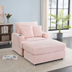 a living room with a pink chair and bookcase on the floor next to a window