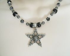 "This beautiful necklace has black pearl beads, black beads with silver engraved stars, seed beads, sterling silver plated filigree beads, pewter silver bead caps and a pewter silver pentagram. 18\" long. Sterling silver plated toggle clasp." Gothic Star-shaped Jewelry For Festivals, Gothic Silver Beaded Necklaces With Black Beads, Gothic Silver Necklace With Black Beads, Silver Gothic Necklace With Black Beads, Handmade Black Star Necklace, Black Spiritual Star-shaped Jewelry, Black Star-shaped Spiritual Jewelry, Gothic Silver Beaded Necklace Perfect For Gifts, Silver Gothic Beaded Necklace For Gift