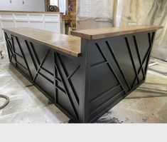 a black and wood bar in the process of being installed