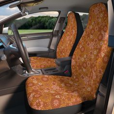 the interior of a car with orange floral seat covers