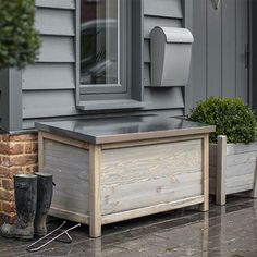 a wooden box sitting on the side of a house