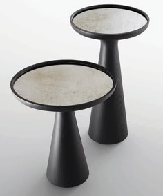 two black and white tables with mirrors on them