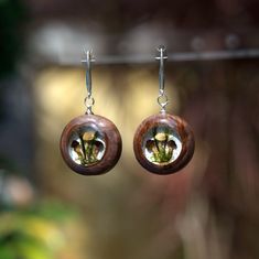 "Mushroom Crystal Earrings. Wood Resin Earrings. Wooden Earrings for Woman. Real Mushroom Jewelry.  ♥  You will be sent exactly the sample that you see in the photo.  ♥♥ Please see the current discounts in the shop announcement: https://www.etsy.com/shop/TSMDecorations  Made very carefully by hand from carefully selected dried mushrooms, moss and wood. Real dried mushrooms and real moss are sealed in ultra-transparent resin. The edging (bezel) is CNC-cut from valuable wood - brown mali burl. Sui Magic Mushroom Art, Epoxy Earrings, Mushroom Crystal, Jewelry Magic, Wood Resin Jewelry, Mushroom Jewelry, Mushroom Earrings, Dried Mushrooms, Earrings Wooden