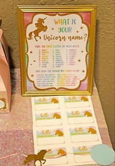 a unicorn themed party with pink, gold and blue decorations on a table next to a bag