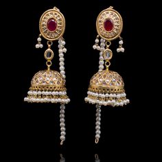 Perfect for luxurious formal festivities! The look includes a pair of earrings and a maang teekah. The beautiful jhumkey earrings are adorned with kundan stones, lab-created gemstones and faux pearl moti. The classic maang teekah is designed with gutka kundan and pearl moti hangings. Approximate earrings length is 3". Gold-plated on high-quality brass as base metal. Made by order. Kindly allow 4-6 weeks for the delivery of this item. For custom or urgent requests, please contact support@alacoutu Party Kundan Jhumkas In Temple Jewelry Style, Ceremonial Kundan Jhumkas, Temple Jewelry Kundan Jhumkas For Party, Kundan Jhumkas For Party, Temple Jewelry Style, Kundan Temple Jewelry Jhumkas For Party, Ceremonial Kundan Jhumkas With Stone Work, Ceremonial Kundan Jhumkas With Latkans, Temple Style Kundan Jhumkas For Party, Party Kundan Tikka With Latkans