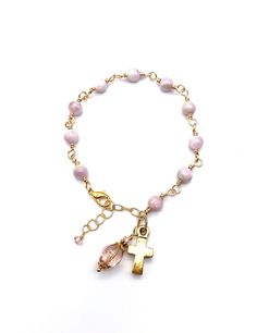 Beautiful, handcrafted vintage-inspired Catholic Heirloom Rosary Devotional Bracelet with Natural Kunzite gemstones. Pater bead is a Crystal Pink Czech glass with Czech glass accent beads and gold bead caps. Each bead is wire wrapped using gold colored wire for strength and beauty. The charm is a beautiful artisan-styled Antiqued Gold cross. This Rosary Bracelet is a lovely way to display your Catholic faith. Specifics: *Ave Beads: Natural Kunzite gemstones 6mm *Pater Bead: Crystal Pink Czech 10 Rosary Bracelet, Gold Cross, Catholic Faith, Bead Caps, Gold Beads, Rosary, Czech Glass, Antique Gold, Wire Wrapped