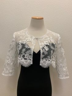 White floral lace wedding handmade bolero. Bridal and evening lace long sleeves jacket. Scalloped edgings and sleeves shrug. Corded Sequined Lace Bolero.    This elegant handmade design has a pretty scalloped lace edge all the way around and on the long-length sleeves as well. A small hook closure finishes it off at the neckline to allow movement and to show your dress or top underneath. The hand-made pearl brooch covering the hook closure gives a more luxurious and stylish look.  Sizes  S - M Evening Shrug With Lace Trim, Elegant Formal Lace With Lace Patchwork, Spring Lace Shrug With Lace Sleeves, Elegant Lace With Lace Sleeves For Party, Elegant Formal Lace With Lace Bodice, Elegant Formal Lace With Bodice Detail, Elegant Lace Party Dress With Lace Sleeves, Spring Party Lace Shrug, Fitted Lace Shrug With Lace Trim