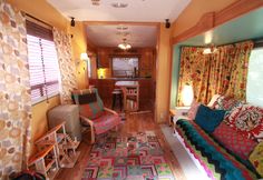 a living room filled with furniture and colorful curtains