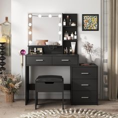 a black vanity with lighted mirror and stool