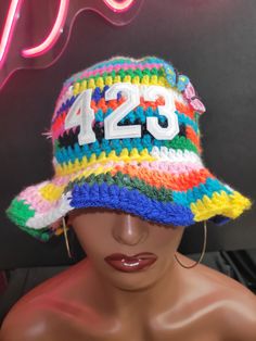 a mannequin's head wearing a multicolored hat with the number 123 on it