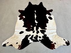 a black and white cowhide rug on the floor