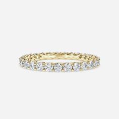 a yellow gold band with round cut diamonds