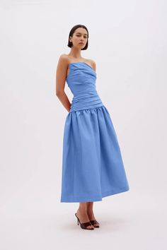 Iconic ruching fuses with ladylike pleating to define the Banks dress. Pictured in stretch-taffeta, it has a subtly asymmetric bodice before extending to a voluminous skirt. The strapless design will really mesmerise onlookers and party guests. Internal fitted bodice Asymmetrical neckline Gathered A-line midi skirt Fabric gathers at bust Back zip closure Runs true to size, we recommend taking your usual size. Model is 5'10 and wears a Rachel Gilbert Size 1 [AU/UK 8 | US 4] Voluminous Skirt, Rachel Gilbert, Asymmetrical Neckline, Black Tie Wedding, Mid Dresses, Party Guests, Fitted Bodice, Black Tie, Mother Of The Bride